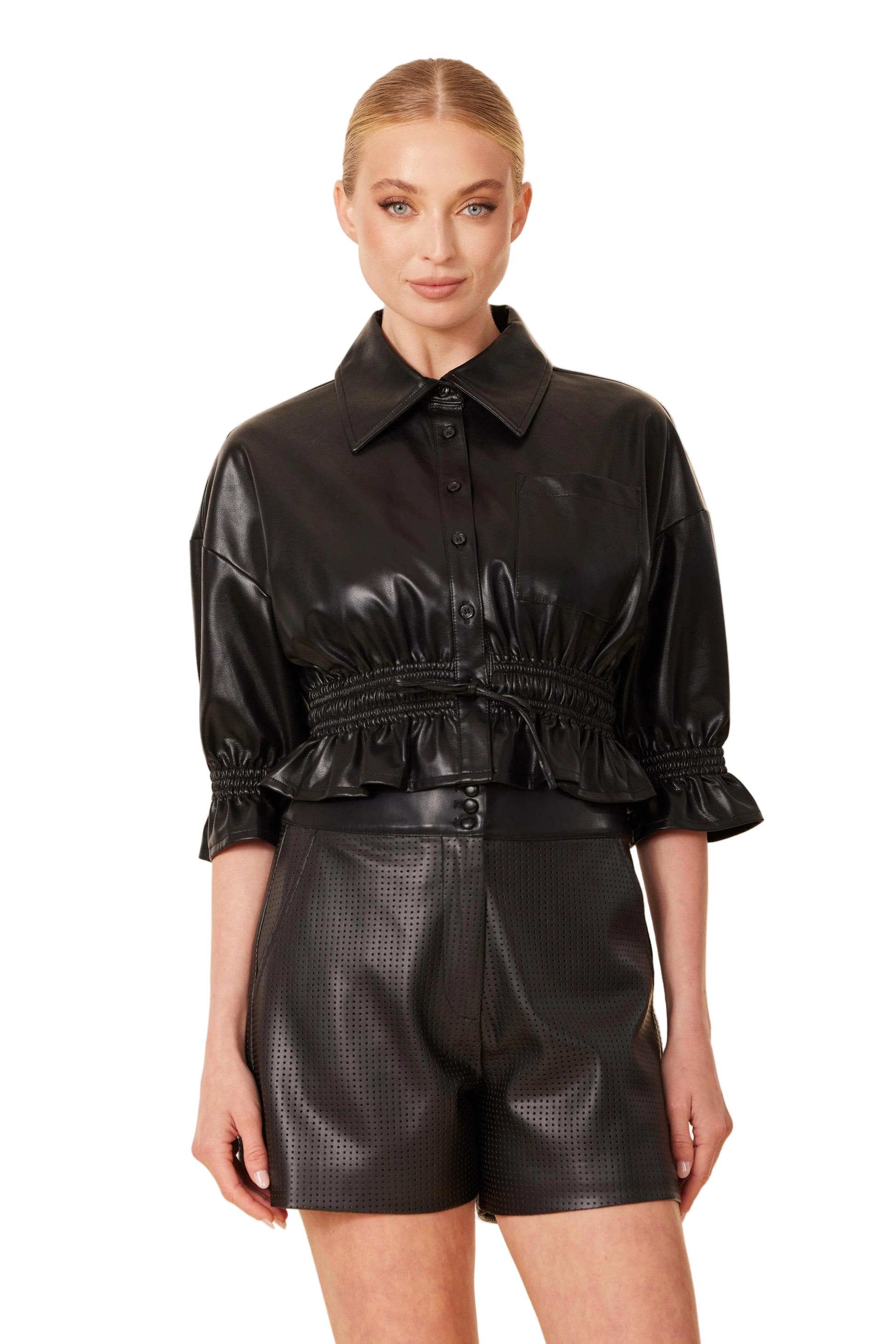 Model wearing black perforated faux leather shorts with side pockets