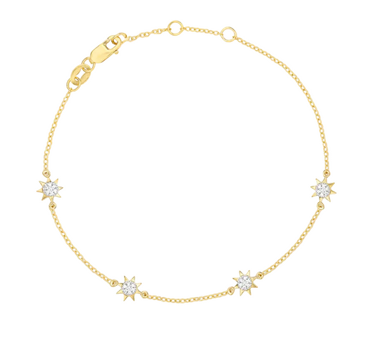 Gold bracelet with star-shaped diamond charms on a white background