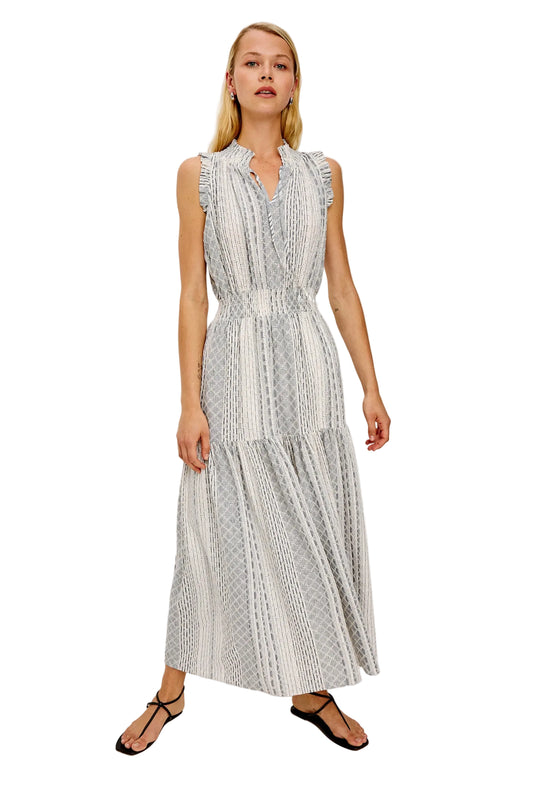 Woman wearing a sleeveless patterned dress on a white background