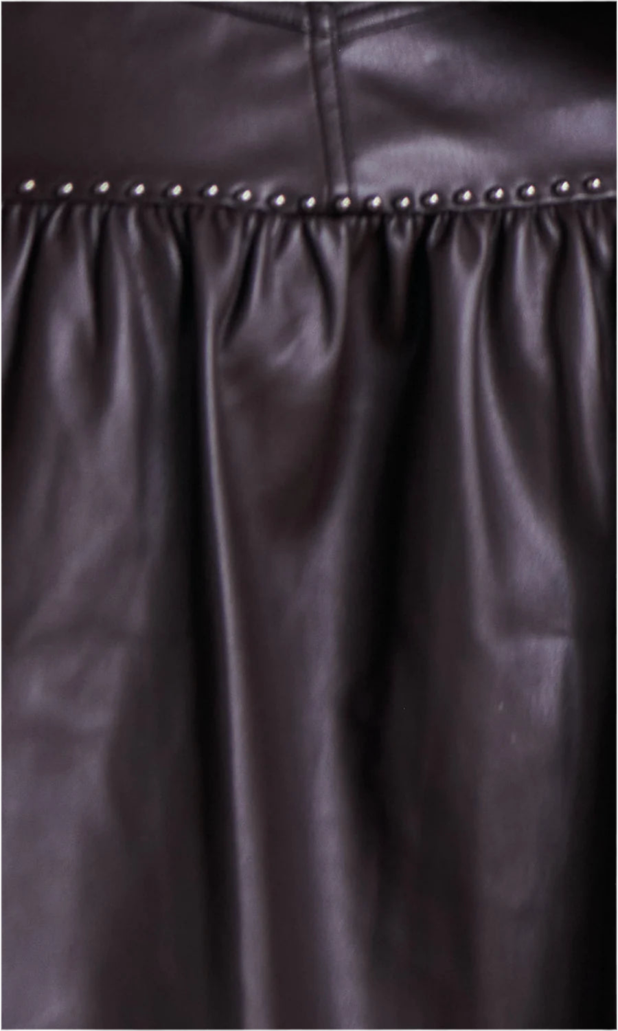 Close-up of stud detailing on Pippi Ruffle Mini Skirt – detailed shot emphasizing the design.