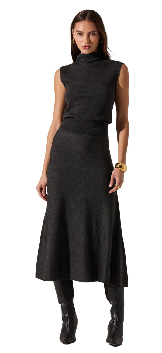 Woman wearing a black sleeveless top and skirt set with black boots on a white background. ASTR Deora Sweater Skirt Charcoal front view