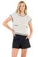 Model wearing cream fringe tweed sleeveless top with crew neckline”