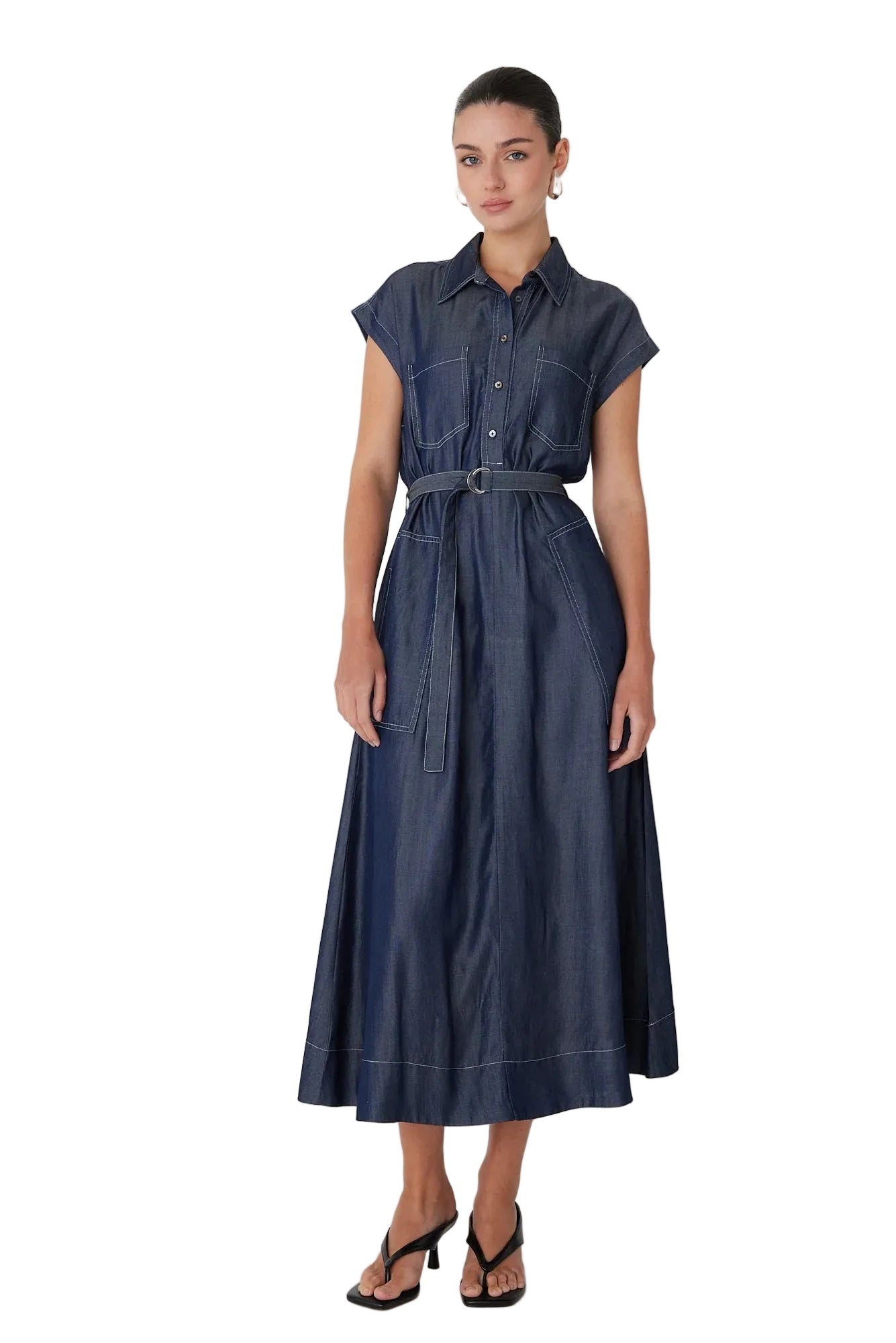 Woman wearing a blue denim dress on a white background