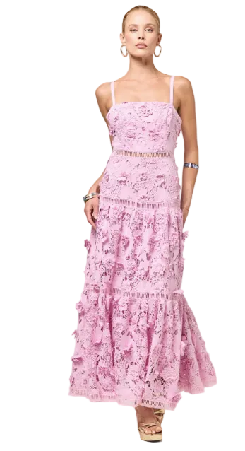 Woman wearing a pink floral dress against a plain background