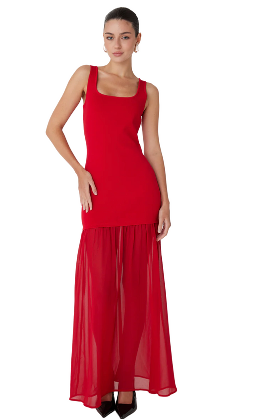 Woman wearing a red dress with a plain background