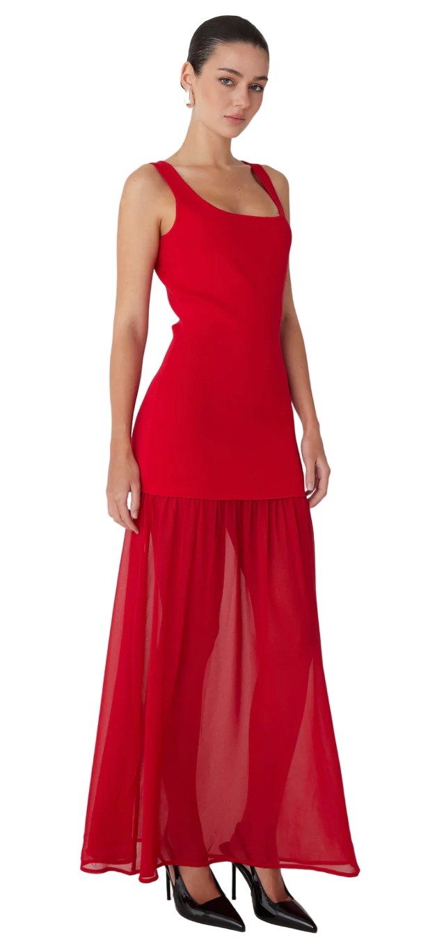 Woman wearing a red dress with a plain background