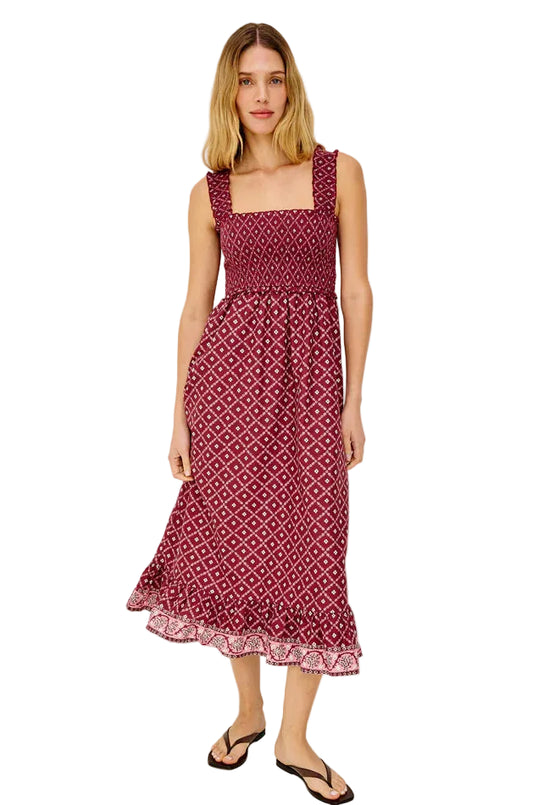 Woman wearing a patterned dress on a plain background